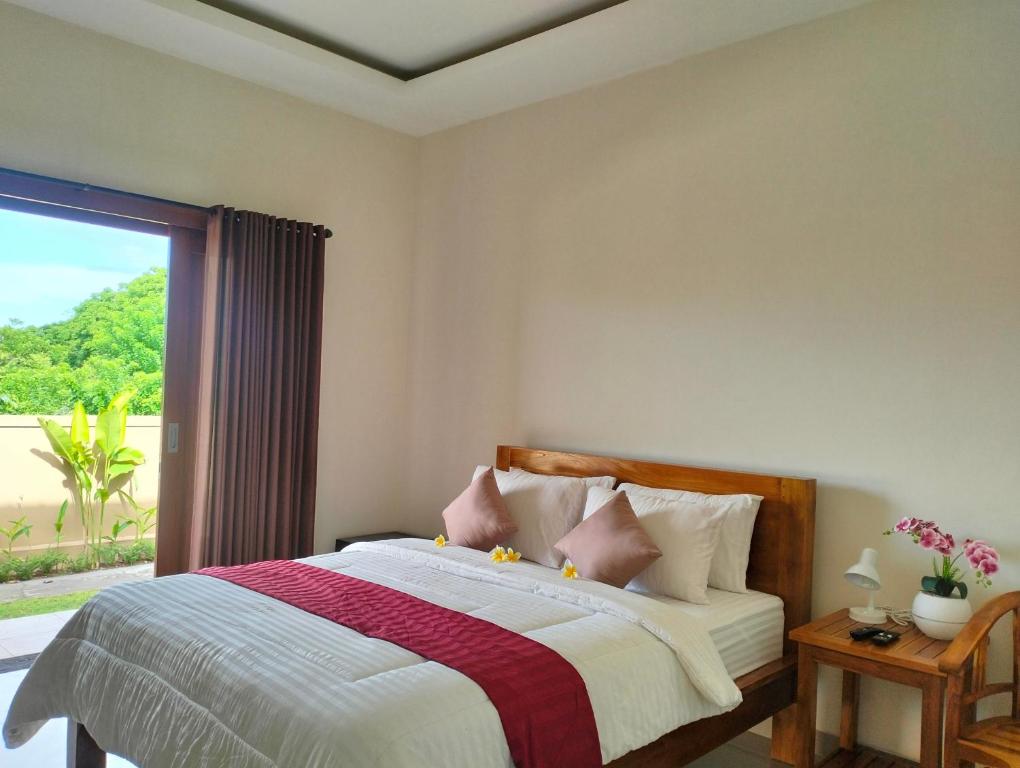Postel nebo postele na pokoji v ubytování Danas Pandawa Homestay