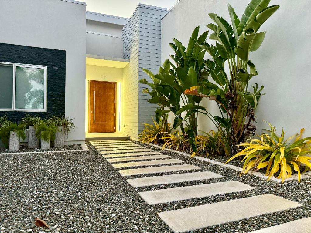 a garden with a walkway in front of a house at Villa Olea in George Town