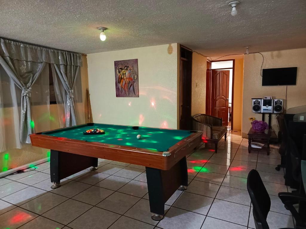 a living room with a pool table in a room at Casa relax in Quito