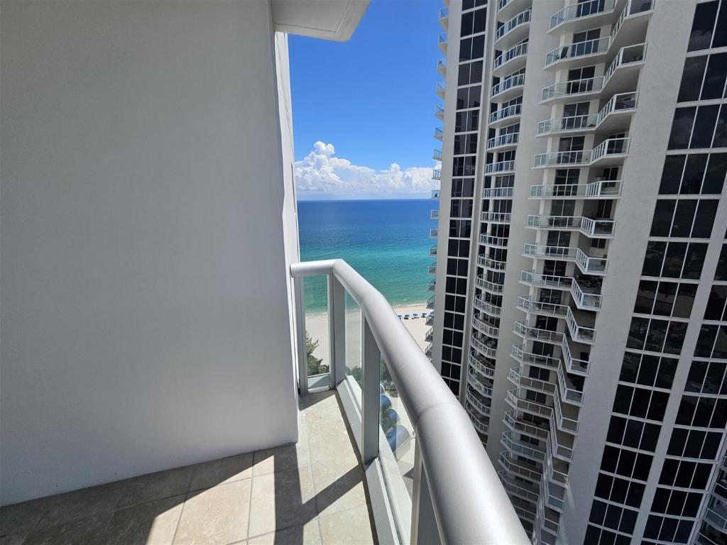 a balcony with a view of the beach and ocean at Mare-1708 B in Aventura