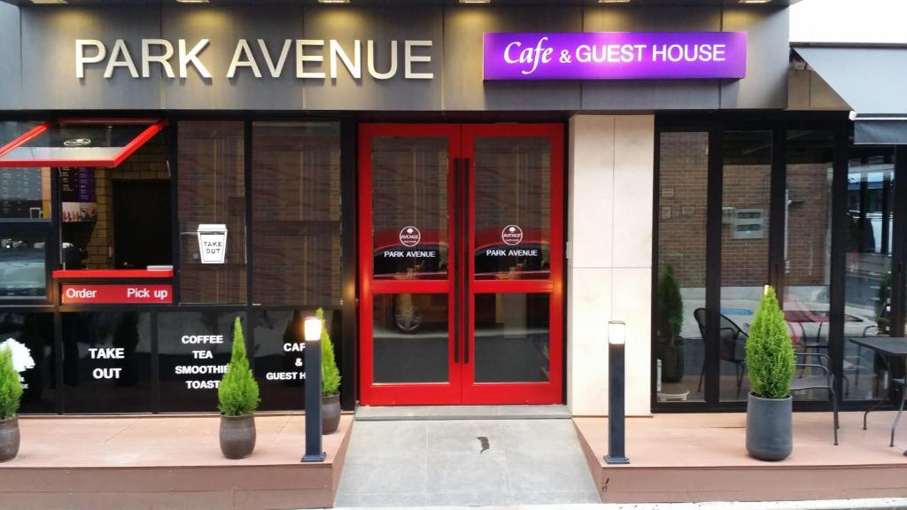 a restaurant with red doors in front of a building at Parkavenue Guesthouse in Seoul