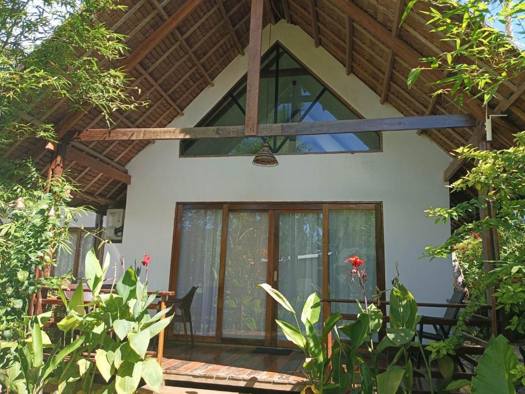 an outside view of a house with a large glass door at EPBliss Siargao in General Luna