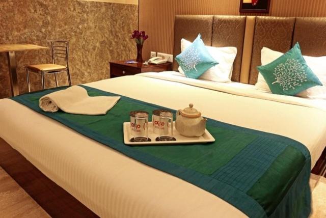a hotel room with a tray of food on a bed at SHREE KRISHNA HOTELS & RESORTS PVT LTD in Salua