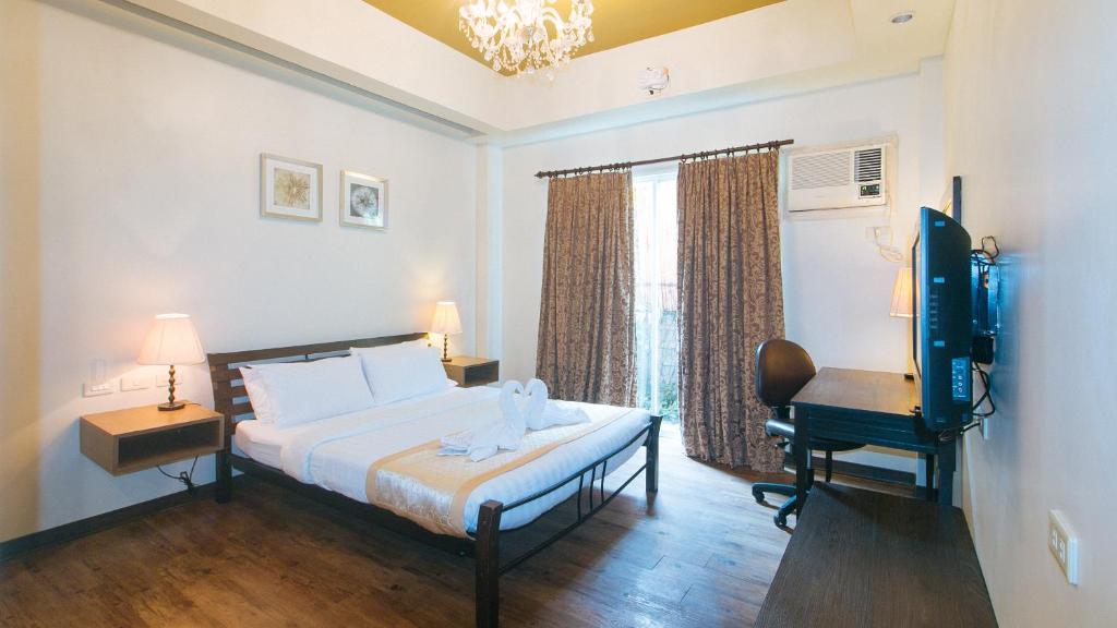 Postel nebo postele na pokoji v ubytování RedDoorz Premium at Anisabel Suites Davao City