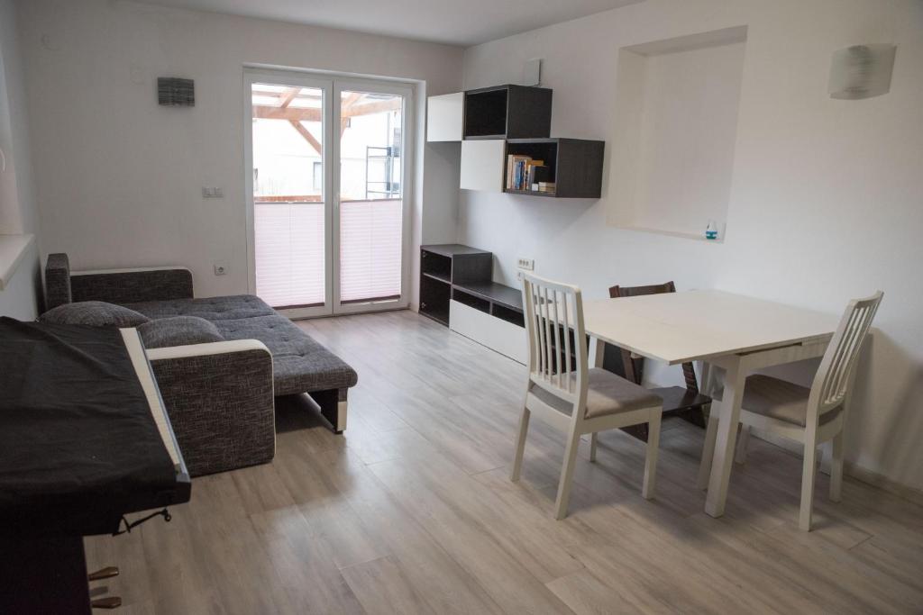 a living room with a table and chairs and a couch at Apartma Katja in Škofja Loka