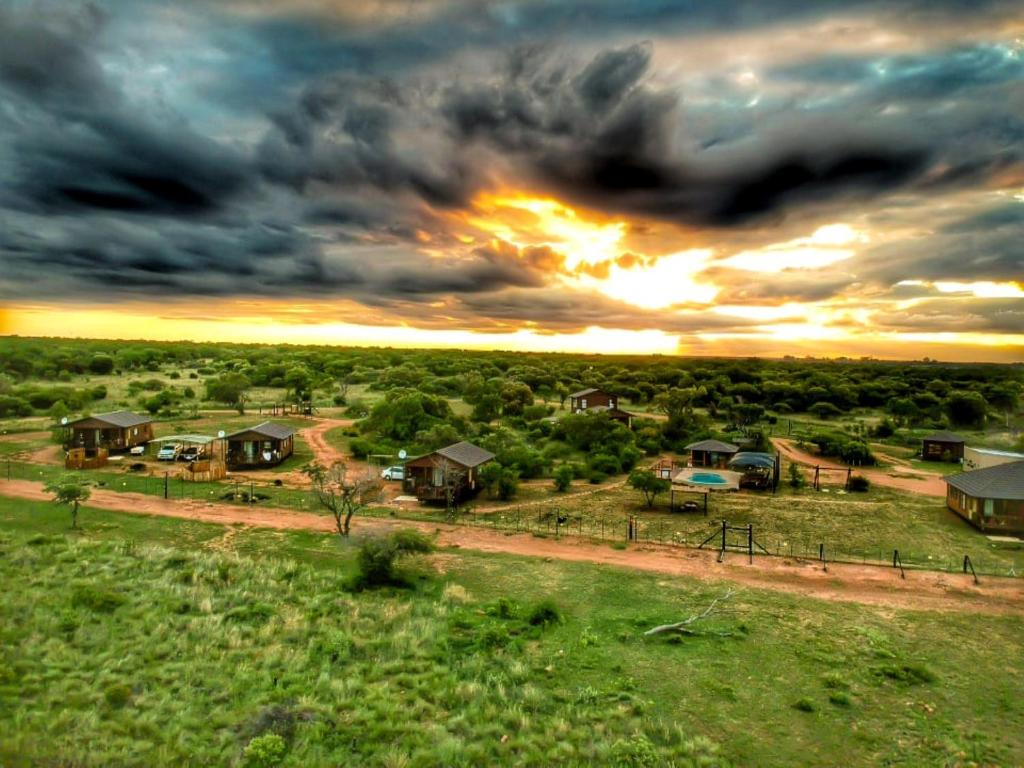 an aerial view of a house with the sunset in the background at Abendruhe Lodge in Pretoria