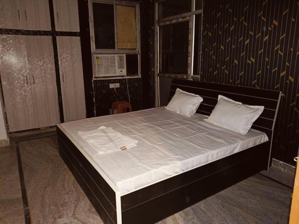 a bed with white sheets and pillows in a room at The Urban Heaven in Lucknow