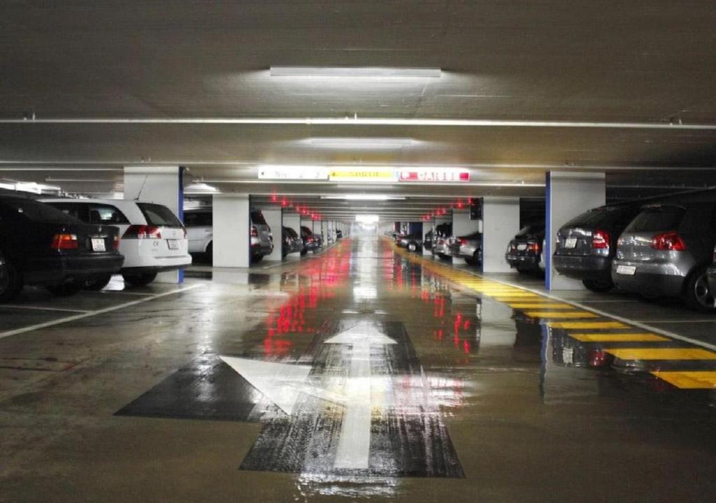 an underground parking garage with cars parked in it at Hôtel du Port in Lausanne