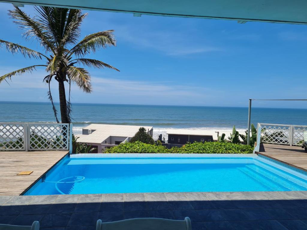 a swimming pool with a view of the beach at Fairview Guesthouse in Ballito