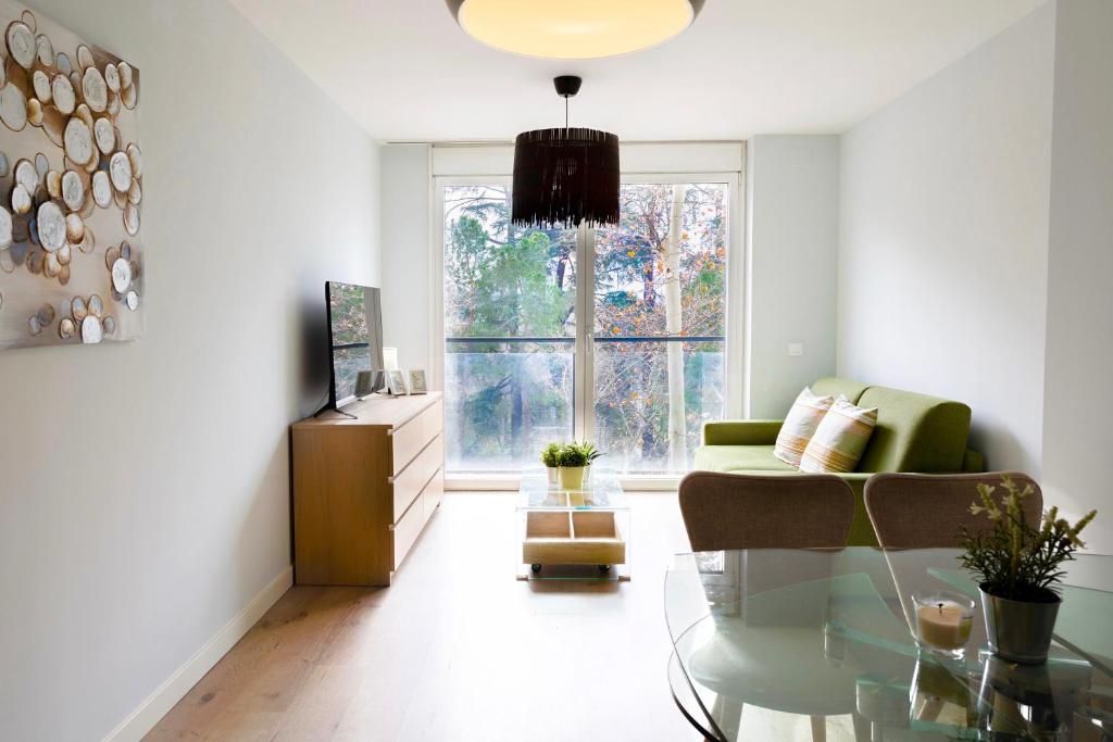 a living room with a couch and a glass table at Apart jardines San Vicente in Madrid
