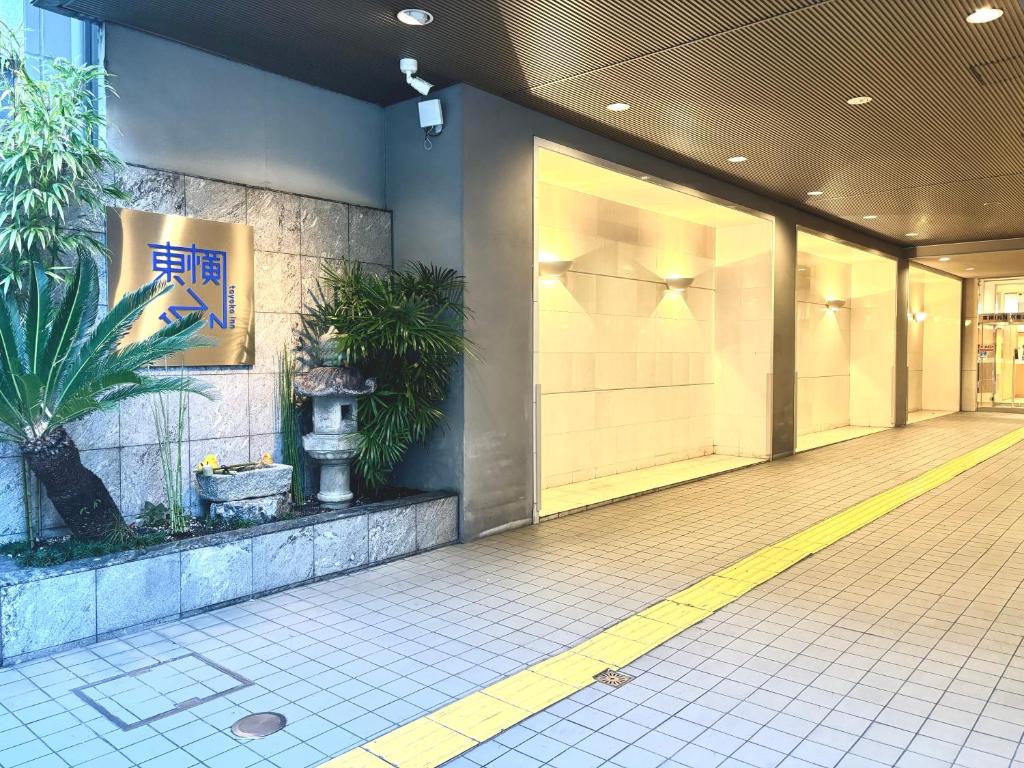 a lobby of a building with plants on the wall at Toyoko Inn Kyoto Shijo-omiya in Kyoto