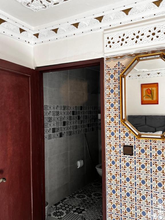 a bathroom with a mirror and a toilet at Riad Palais D'Or in Rabat