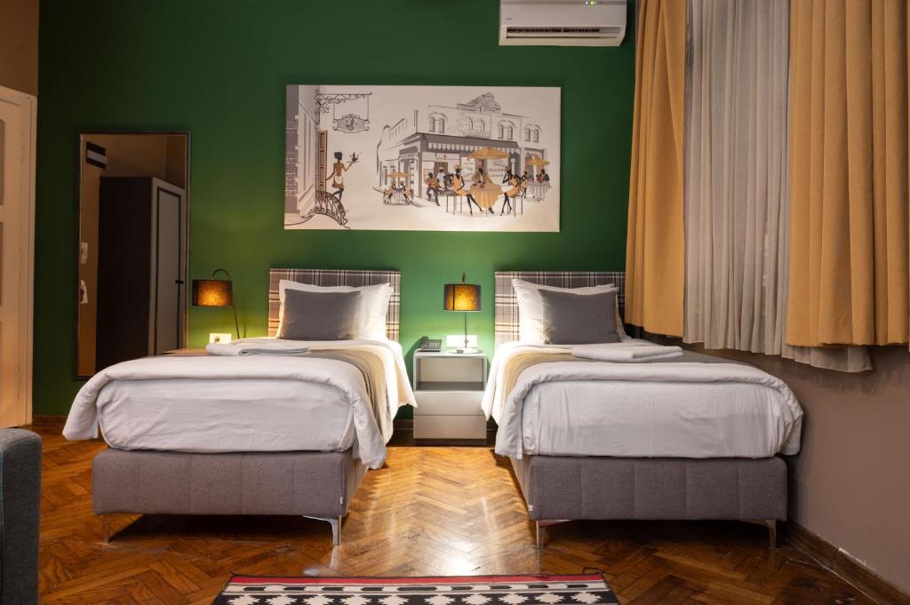 Postel nebo postele na pokoji v ubytování Hotel London B&B