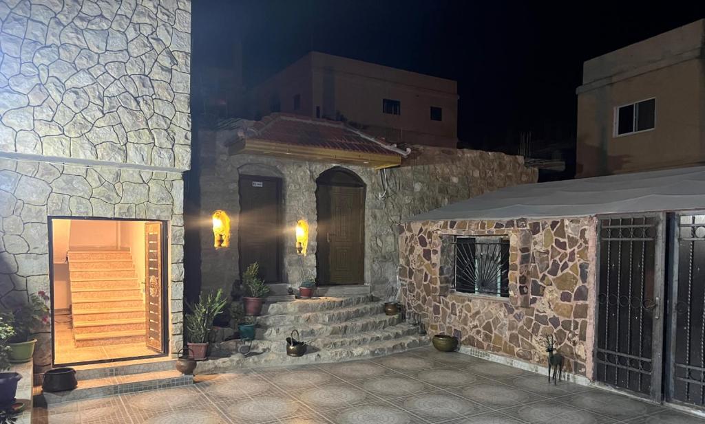 un edificio in pietra con una porta e una scala di Eman house a Wadi Musa