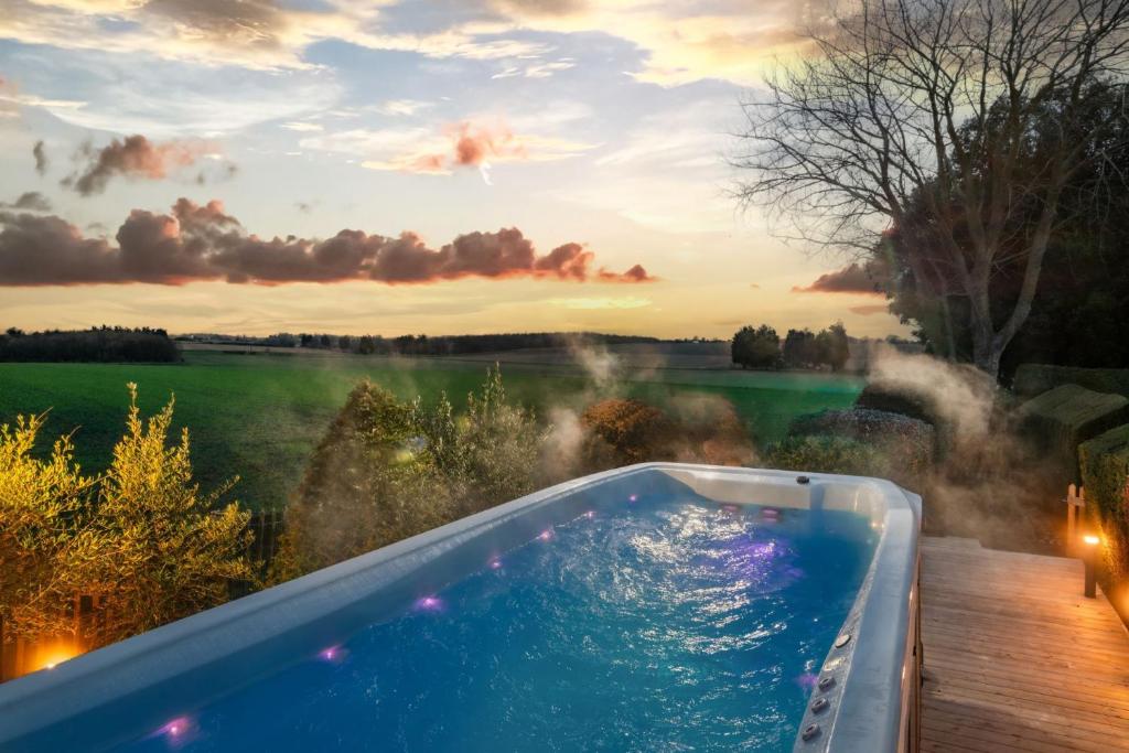 a bath tub with a view of a lake at Sunset Cottage in Sandwich