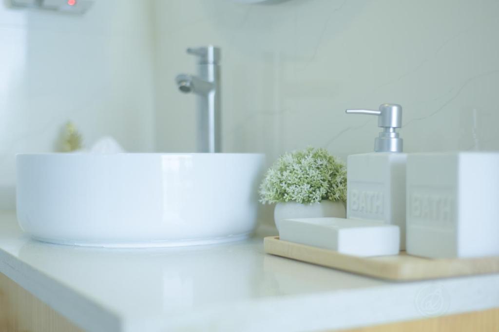 a bathroom counter with a sink and plants on it at Lazzlla beach front apartments in Hulhumale