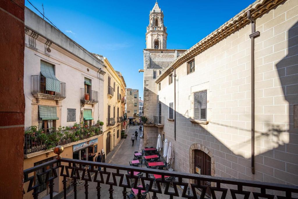 a view of an alley with a clock tower at AT137 Abadia in Torredembarra
