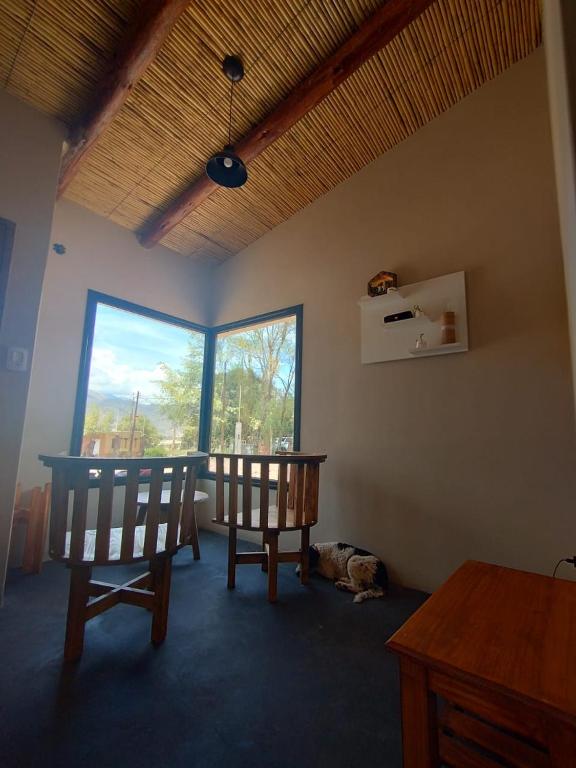 a room with two chairs and a table and a window at CABAÑAS RIVIERA in Huacalera