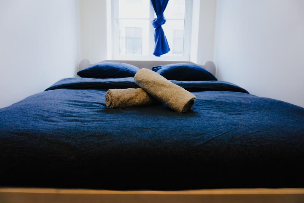 a stuffed animal is sitting on a bed at Lighthouse Hostel & Rooms in Rīga