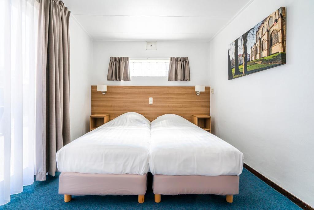 Postel nebo postele na pokoji v ubytování Hotel Hulst