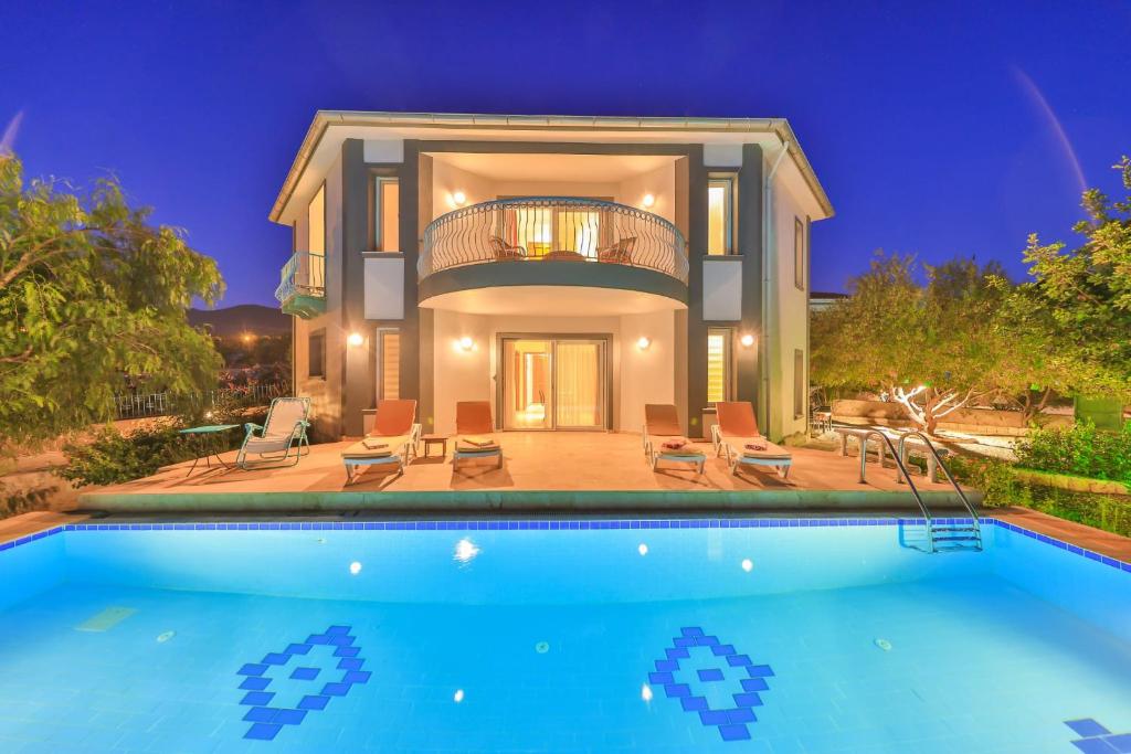 a house with a swimming pool in front of a house at LaCitrus Villa Hotel in Kas