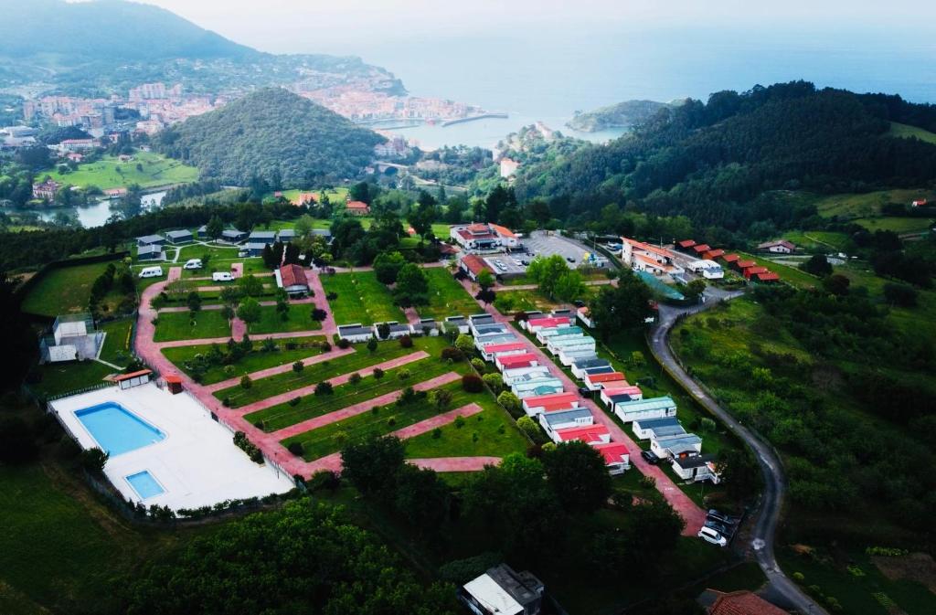 an aerial view of a parking lot with a park at Camping & Bungalows Leagi in Mendexa