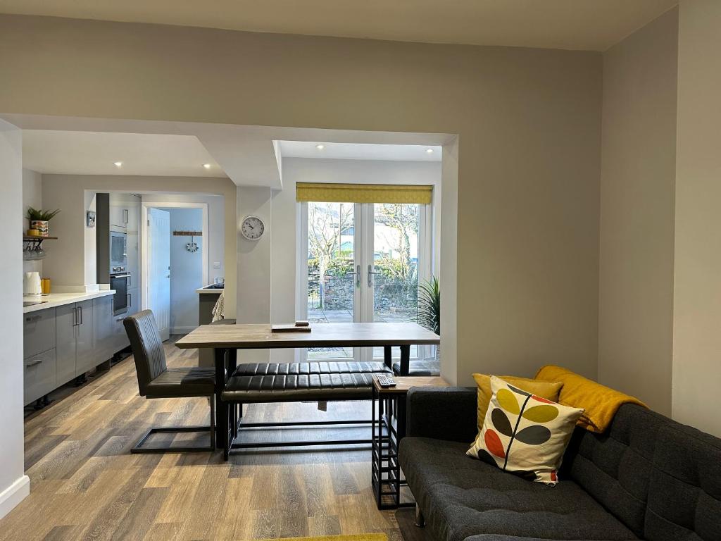 a living room with a table and a couch at Homely house at the foot of Snowdonia in Llanberis