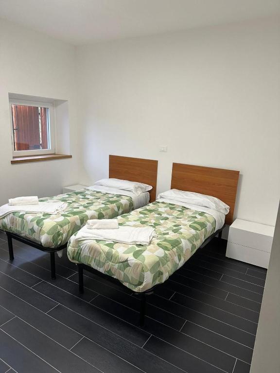 A bed or beds in a room at La corte dell'ulivo