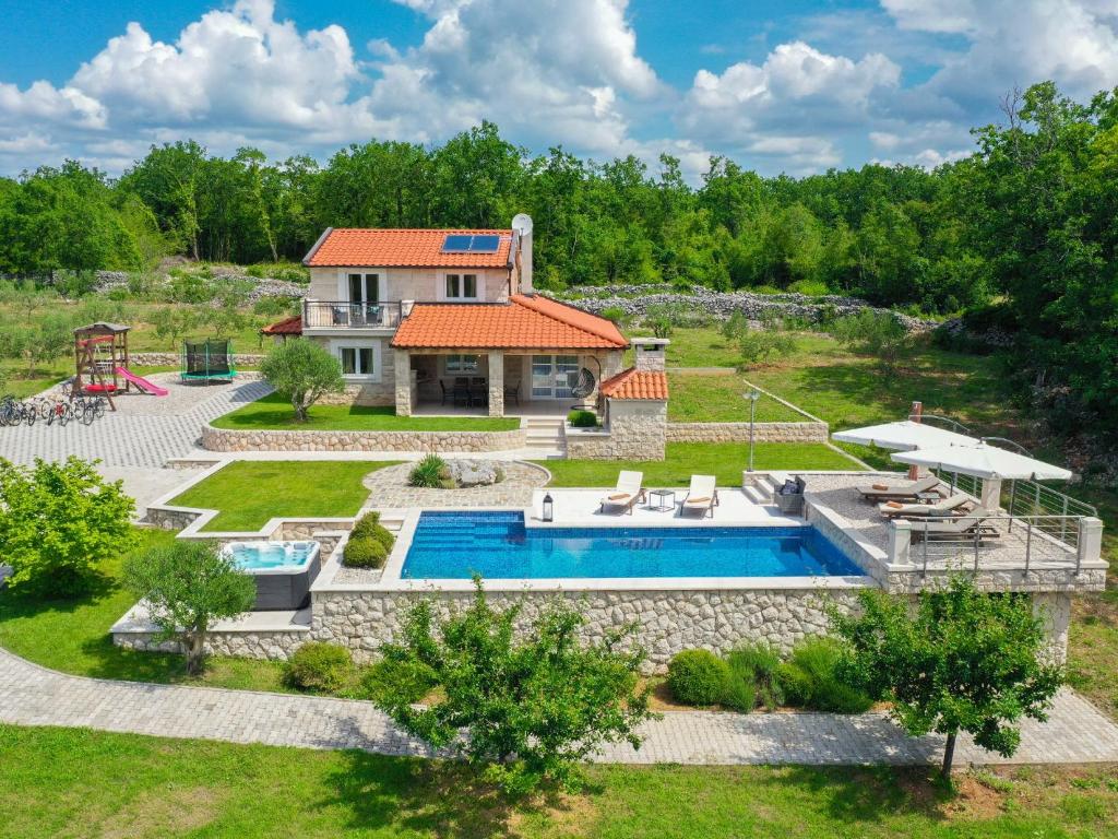 an aerial view of a house with a swimming pool at Villa Drazana in Imotski