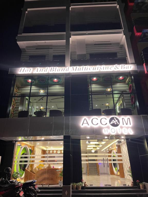 a building with a sign on the side of it at Accom Hotel in Ilām