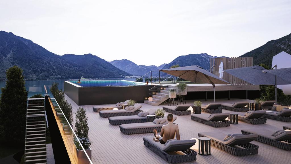 uma representação de um resort com sofás e uma piscina em Familienresort Buchau em Maurach