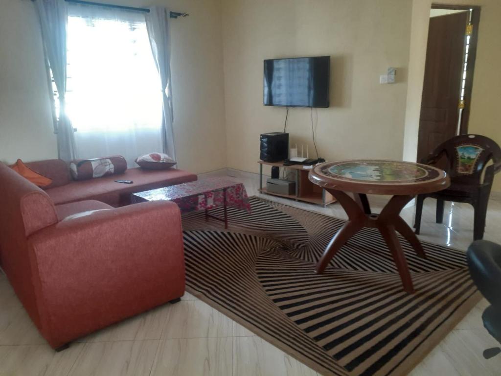 a living room with a couch and a table at Ngala Blessed Apartment in Malindi