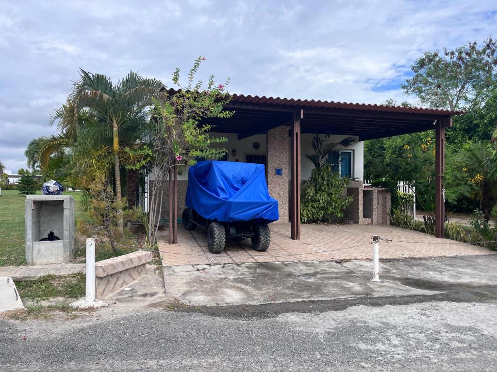 a blue tarp is parked in front of a house at Napa Village Playa Blanca Resort in Río Hato