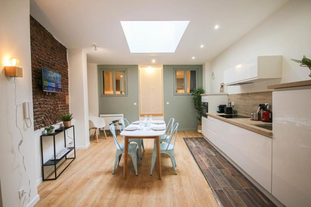 a kitchen and dining room with a table and chairs at Lille Grand Place - Apartment With 2 Bedrooms in Lille