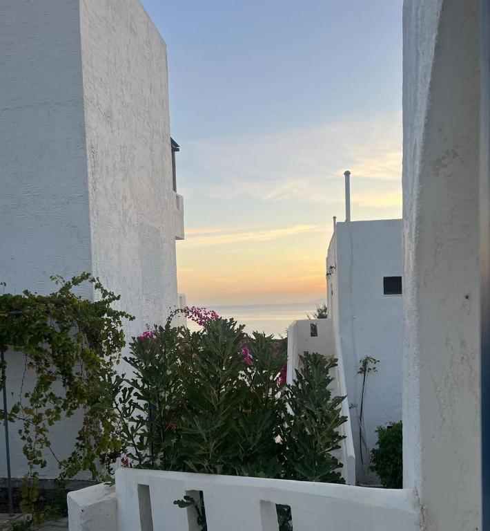 a view of a sunset from a white building at Thalia Bloom Villa Apartments in Agia Pelagia