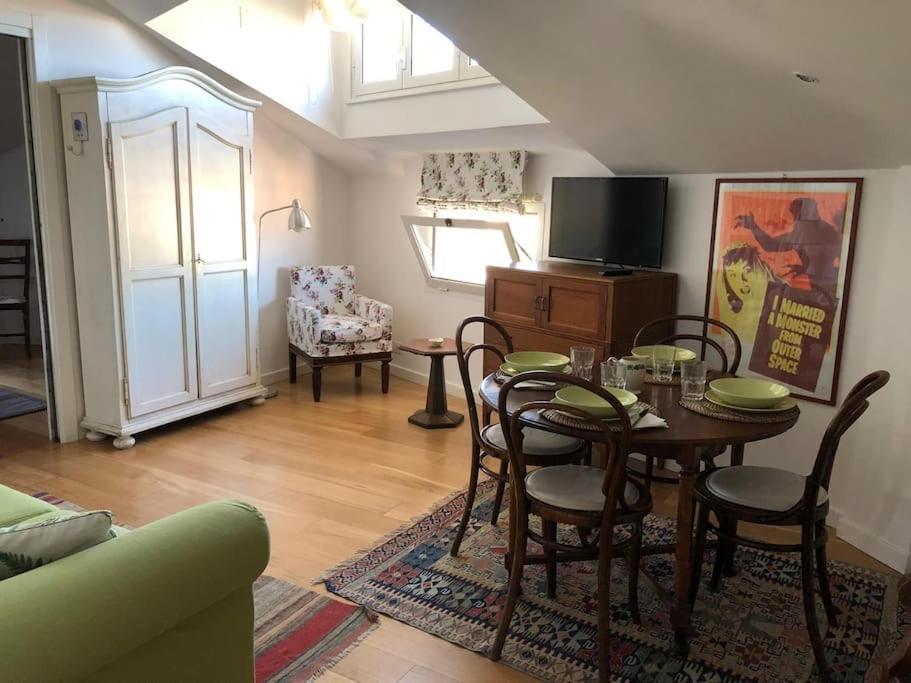 a living room with a table and chairs and a couch at Walking distance from Via Veneto in Rome