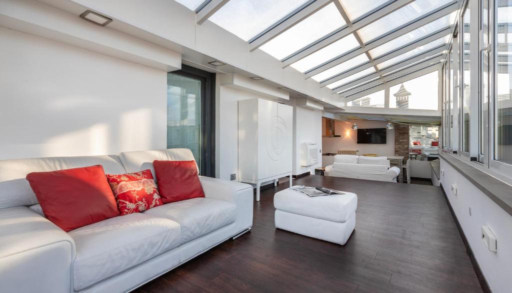 a living room with a white couch and red pillows at Italianway Comfort - Torino 57 B in Milan