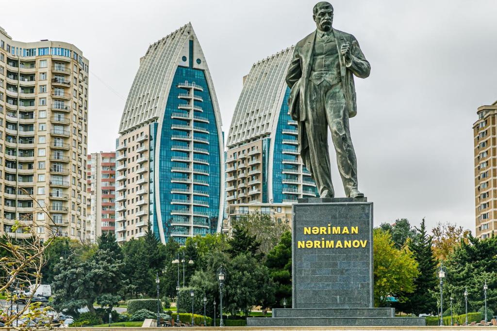 a statue of a man in front of buildings at SEA VIEW HOTEL APART in Baku