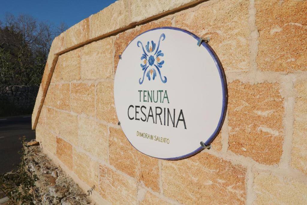 a sign on the side of a brick wall at Cesarina Suite Apartment in Alessano