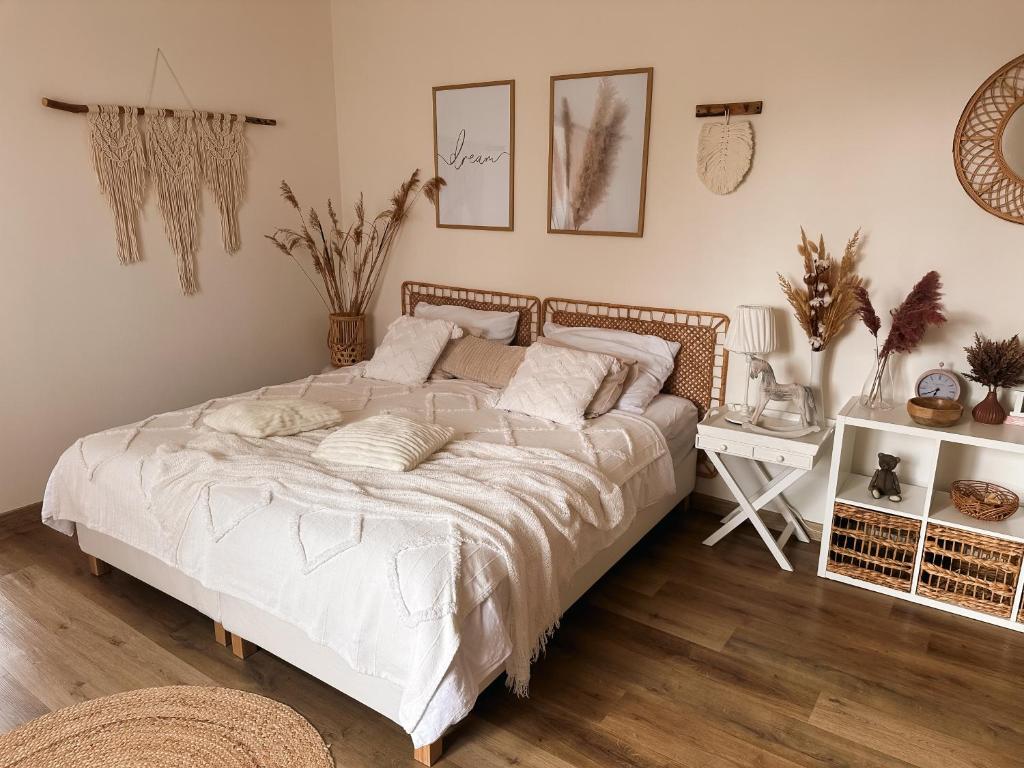 Apartmány Zahražany في موست: غرفة نوم مع سرير أبيض كبير ومكتب