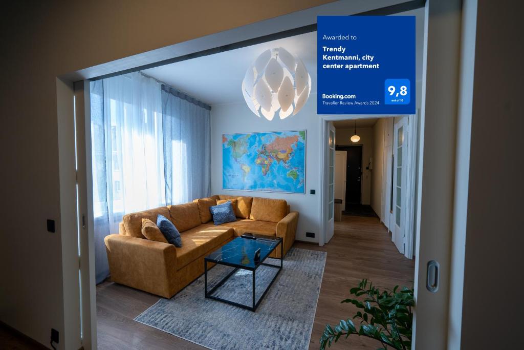 a living room with a couch and a sign at Trendy Kentmanni, city center apartment in Tallinn