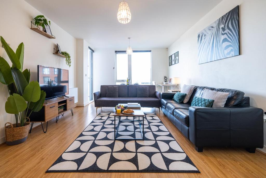 a living room with a couch and a table at Brightleap Apartments - The Hub in Milton Keynes