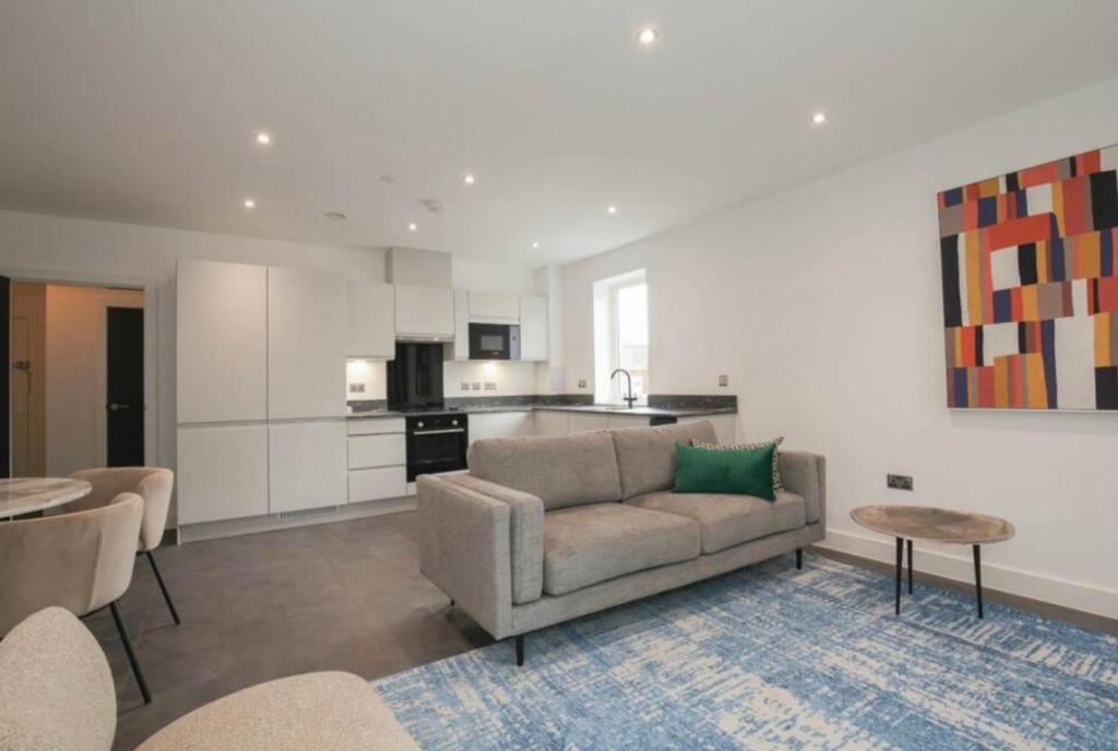 a living room with a couch and a kitchen at 2 Bedroom Apartment In Kew Bridge in Kew Bridge