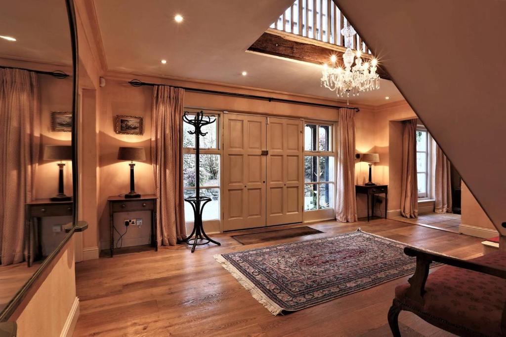 a large living room with a chandelier and a hallway at Rare Opportunity to stay on Unique Private Estate in Malahide