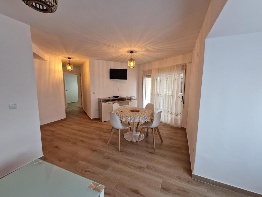 a dining room with a table and chairs in a room at CAMPELLOBEACH in El Campello
