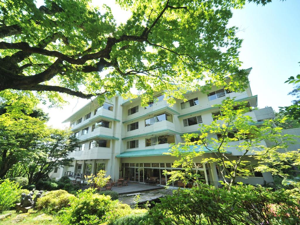 a white building with trees in front of it at Choseikan in Agano