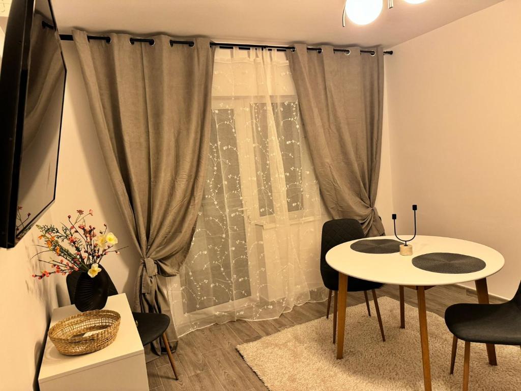 sala de estar con mesa y ventana en Apartament Mahmudia - Casa Anastasia Murighiol en Mahmudia