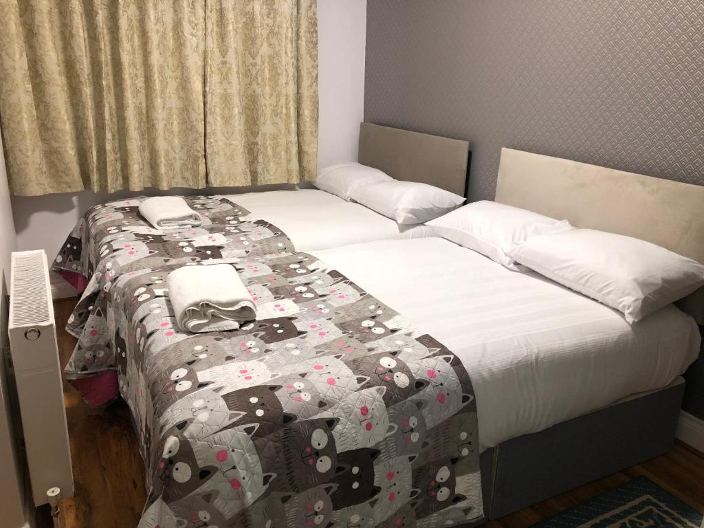 two twin beds in a room with a bedspread with hello kitty at 36 King Star Hotel in London
