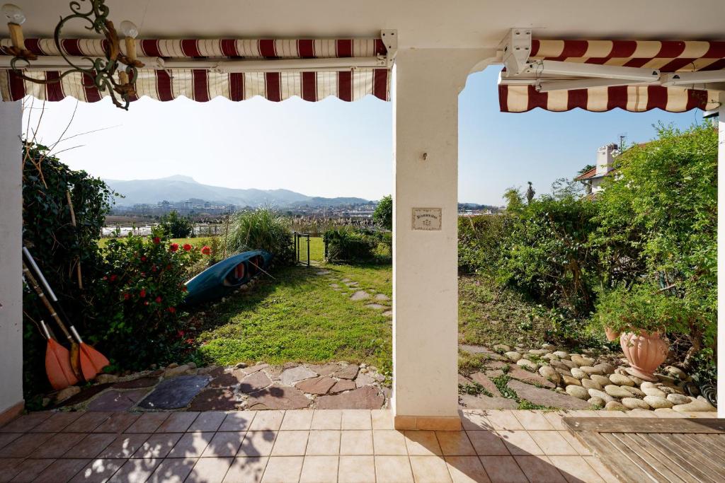 an open patio door with a view of a yard at Bidasoabanks in Hendaye