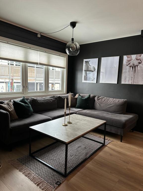 a living room with a couch and a coffee table at Oppdal Alpintun ski in ski out in Oppdal